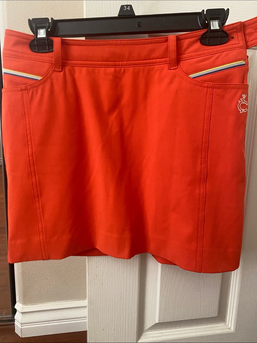 Women's Mini Skirt in Vivid Orange with Subtle Logo